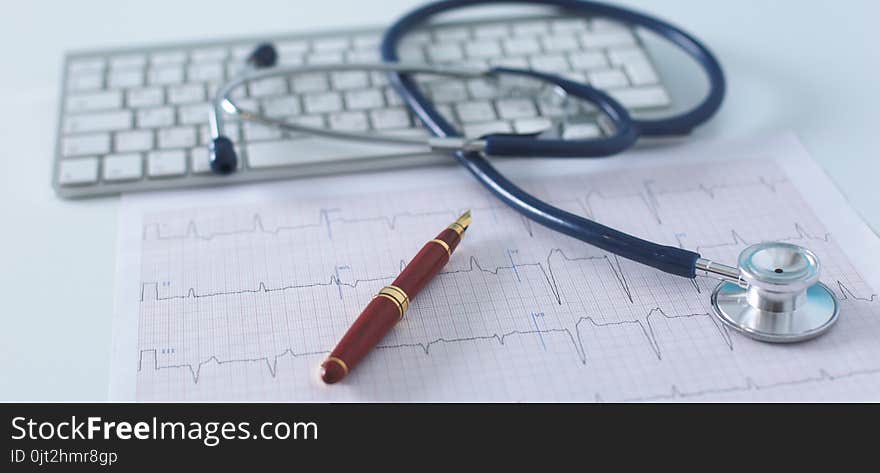 Stethoscope on cardiogram concept for heart care on the desk.blue toned images