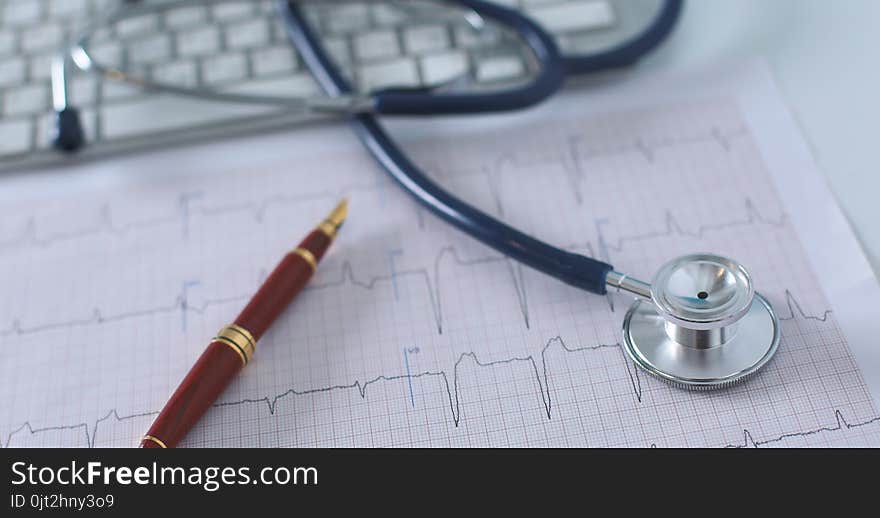 Stethoscope On Cardiogram Concept For Heart Care On The Desk.blue Toned Images