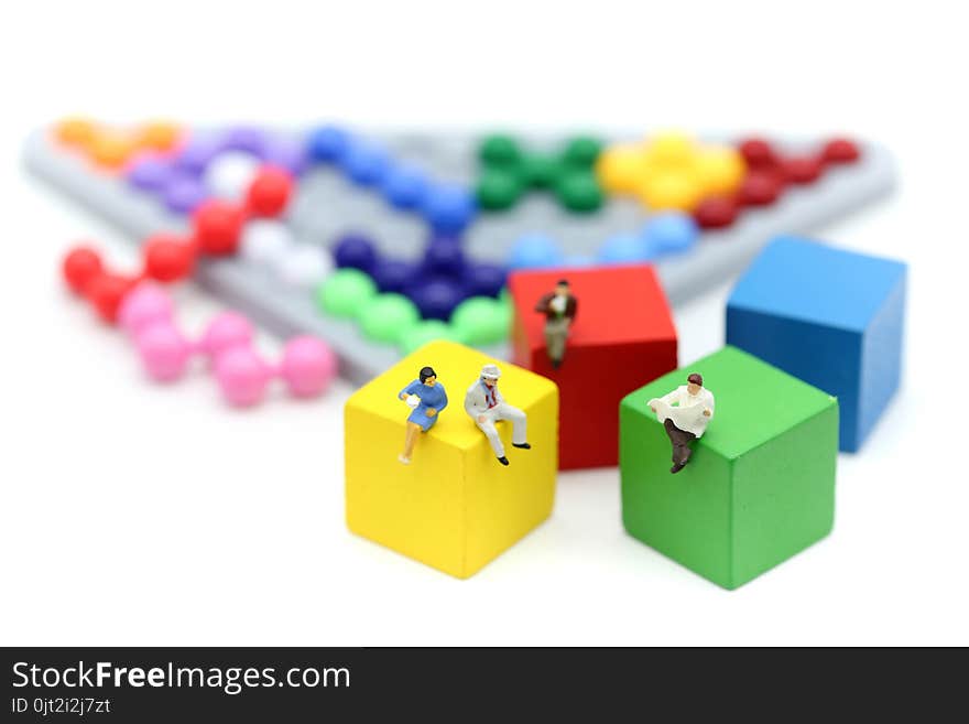 Miniature people : Businessman with Colorful abacus and kids toy,business and education concept.