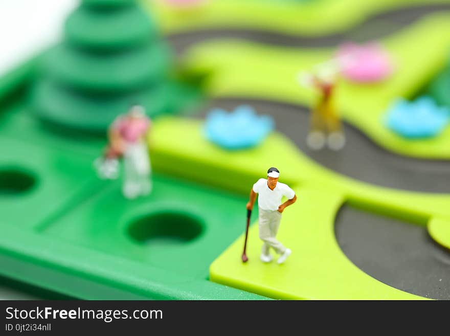 Miniature people : golfer stand with children`s toys collection