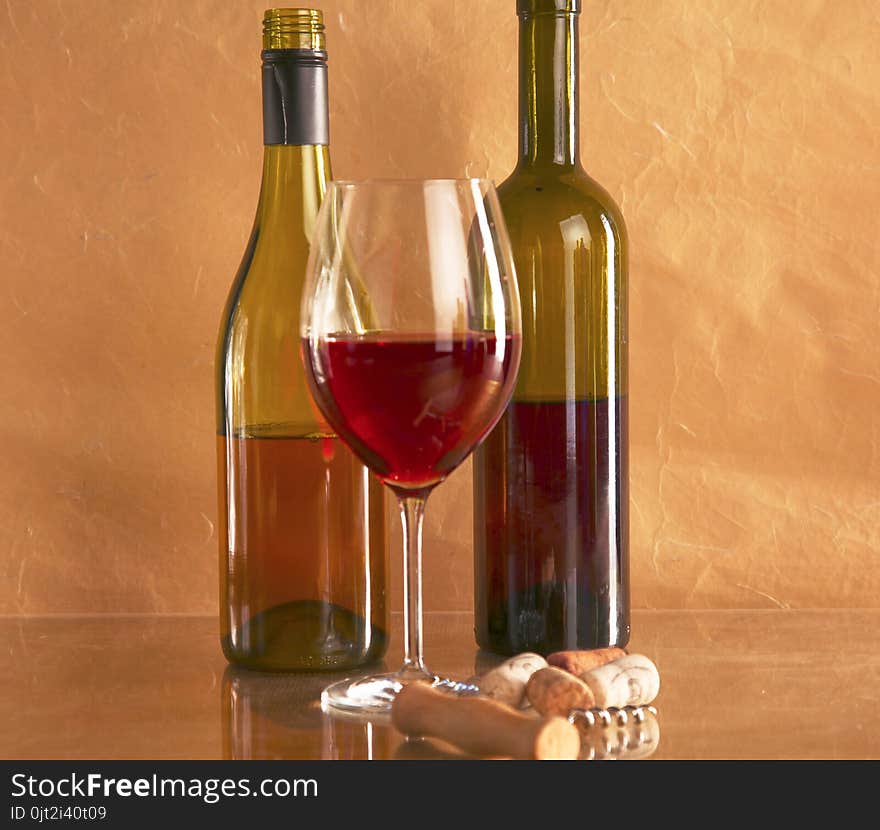 Still life with glass and bottle of wine, cheese and grapes.