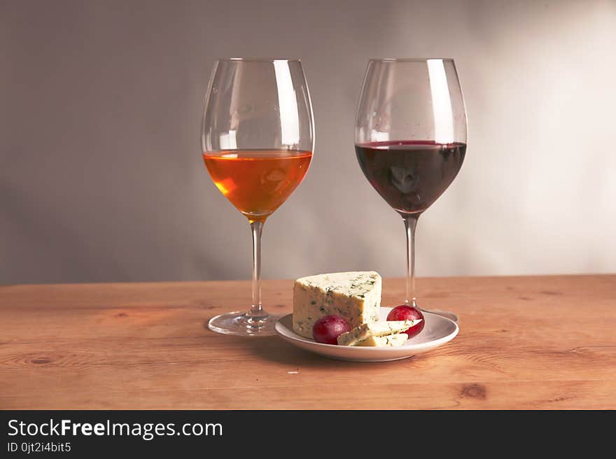 Still life with glass and bottle of wine, cheese and grapes