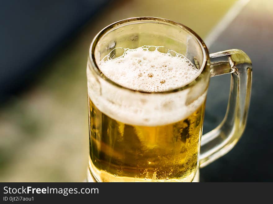 Drinking Beer in Summer Concept. Glass of Beer on Balcony. Warm Tone