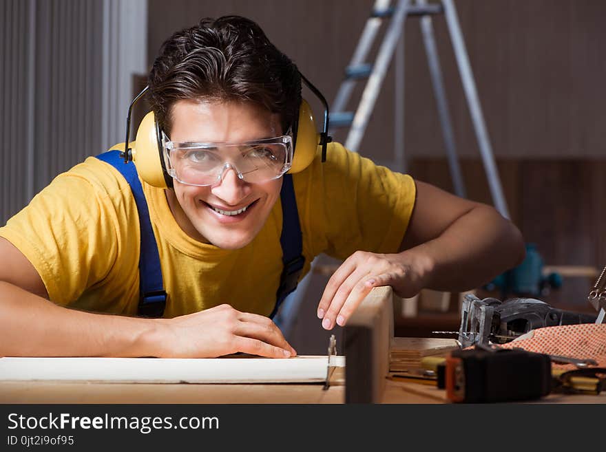 The worker working in repair workshop in woodworking concept