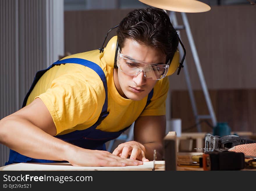 The worker working in repair workshop in woodworking concept