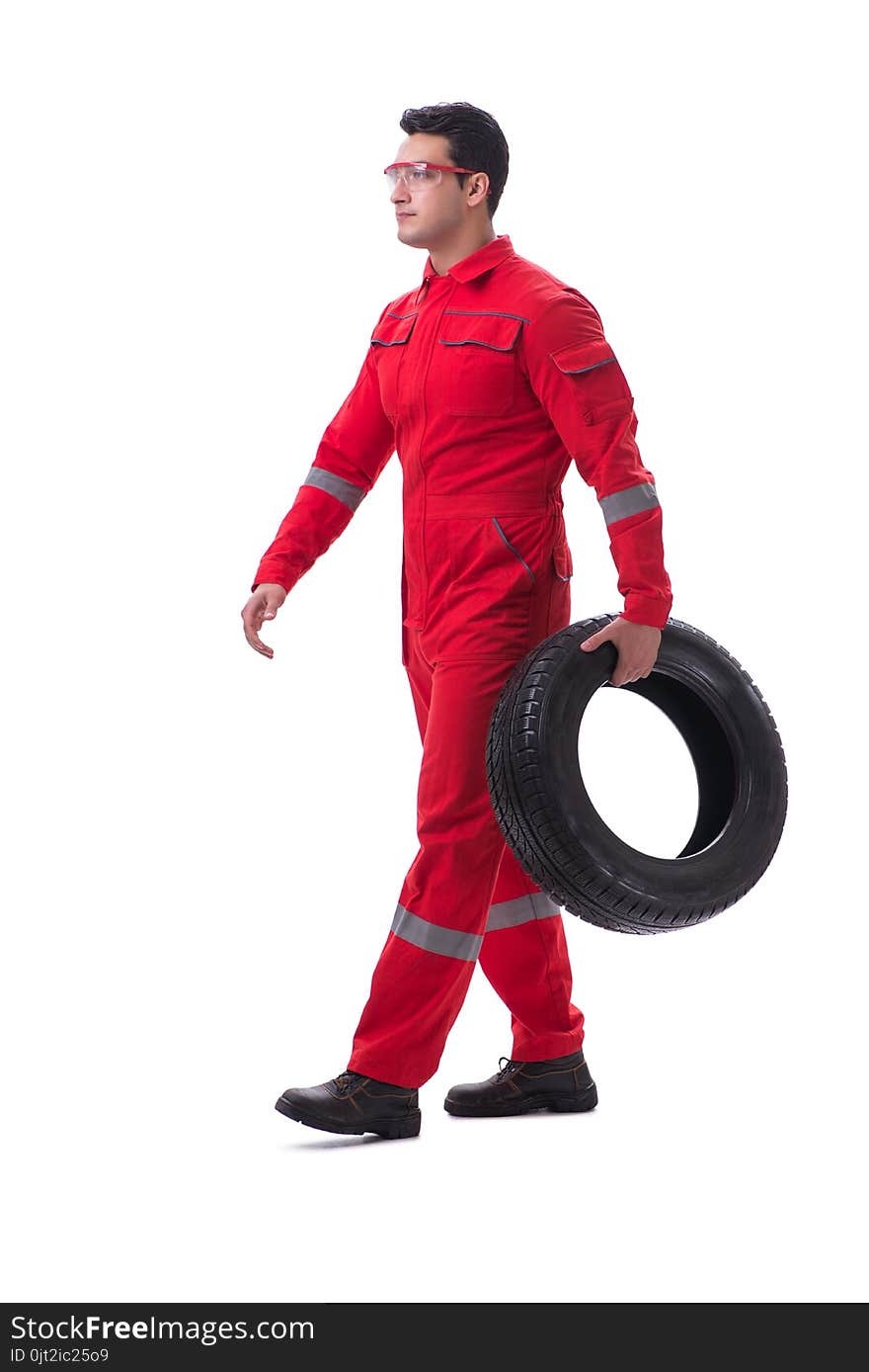 Young tyre repairman in red coveralls isolated on white background