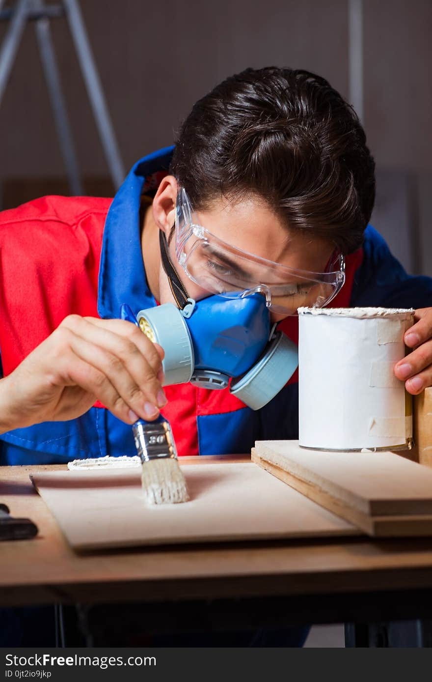 The Young Man Gluing Wood Pieces Together In Diy Concept