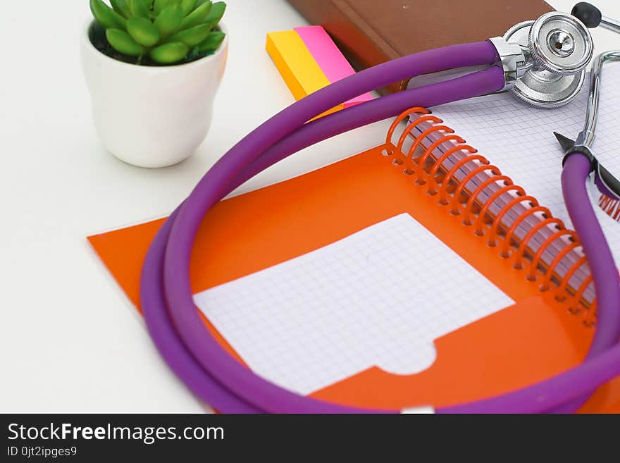 Doctor`s workspace working table with patient`s discharge blank paper form, medical prescription, stethoscope on desk.