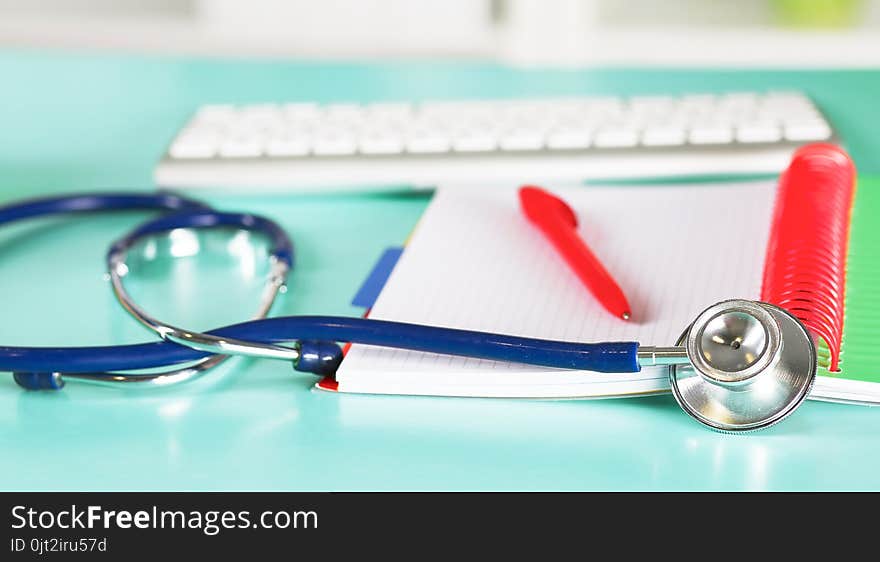 Doctor`s workspace working table with patient`s discharge blank paper form, medical prescription, stethoscope on desk