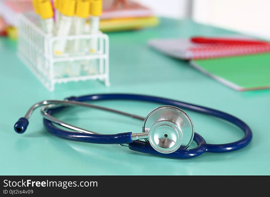 Doctor`s workspace working table with patient`s discharge blank paper form, medical prescription, stethoscope on desk.