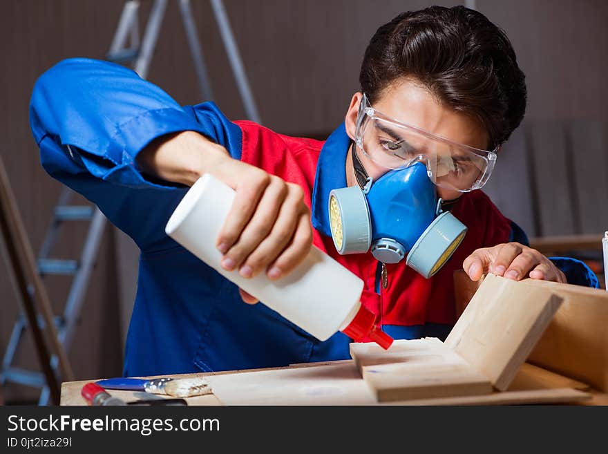 The Young Man Gluing Wood Pieces Together In Diy Concept