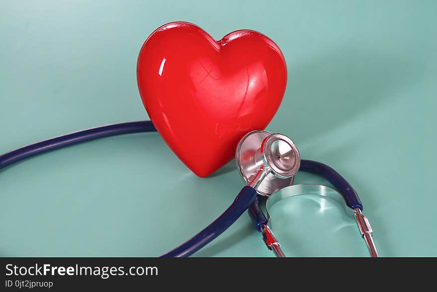 Red Heart With Stethoscope On Blue Wooden Background. Copy Space. Valentines Day.