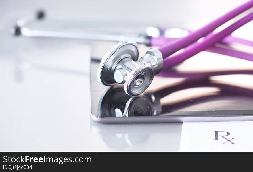 Doctor`s workspace working table with patient`s discharge blank paper form, medical prescription, stethoscope on desk.