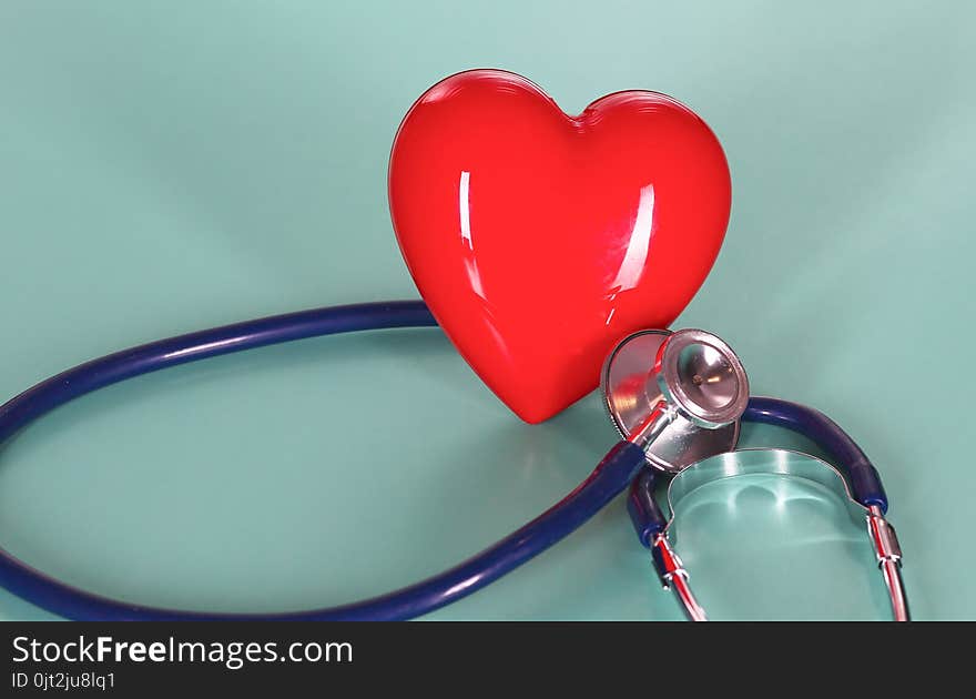 Red Heart With Stethoscope On Blue Wooden Background. Copy Space. Valentines Day.