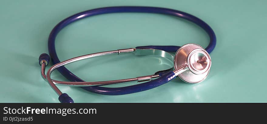 Medical Concept. Top view of stethoscope, clipboard, pen and eye glasses on blue background. Flat lay and copy space.