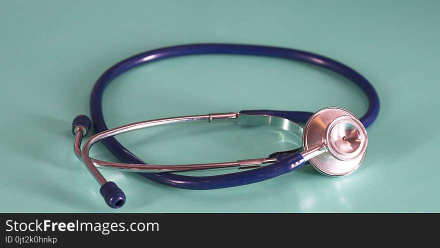 Medical Concept. Top view of stethoscope, clipboard, pen and eye glasses on blue background. Flat lay and copy space