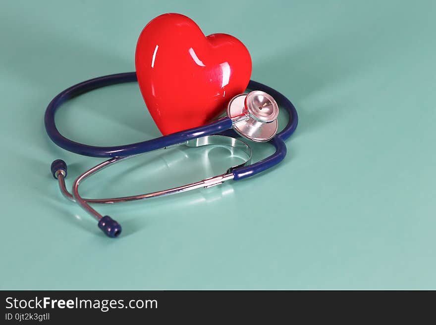 Red Heart With Stethoscope On Blue Wooden Background. Copy Space. Valentines Day.