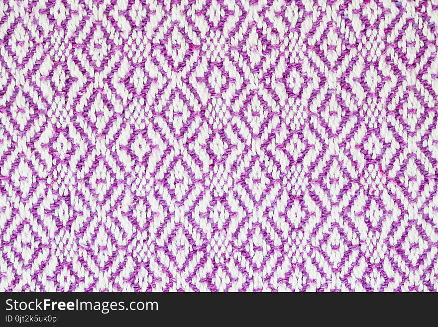 Texture of the fabric surface made of knitted natural cotton fiber, purple-lilac pattern, abstract background. Texture of the fabric surface made of knitted natural cotton fiber, purple-lilac pattern, abstract background