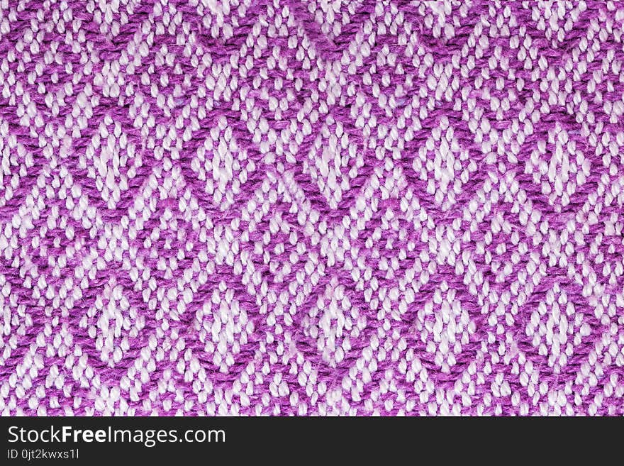 Texture of the fabric surface made of knitted natural cotton fiber, purple-lilac pattern, abstract background. Texture of the fabric surface made of knitted natural cotton fiber, purple-lilac pattern, abstract background