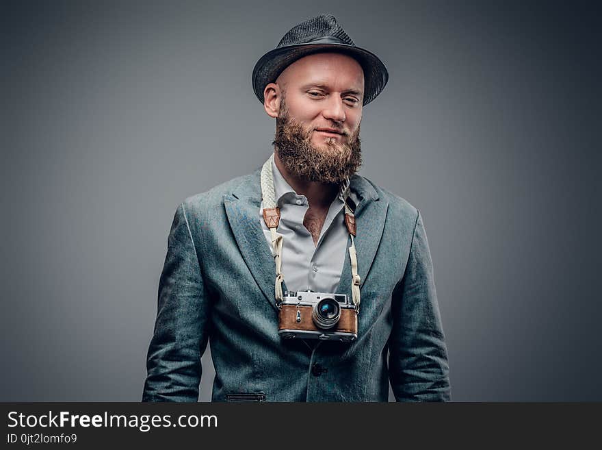 A Man Dressed In A Grey Jacket And Felt Hat Holds An SLR Photo C