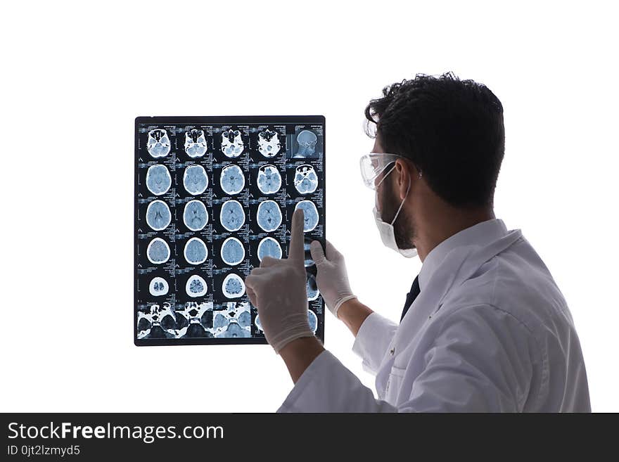 The Young Doctor Looking At X-ray Images Isolated On White