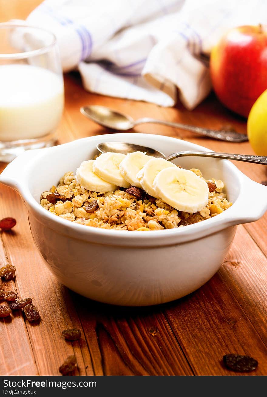 Healthy breakfast. Muesli with banana,raisins and milk