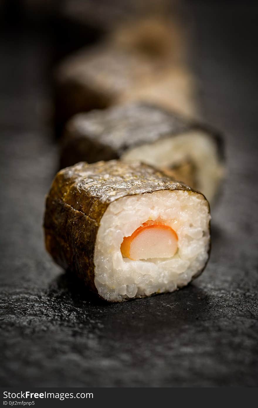 Traditional japanese sushi rolls hosomaki on stone desk