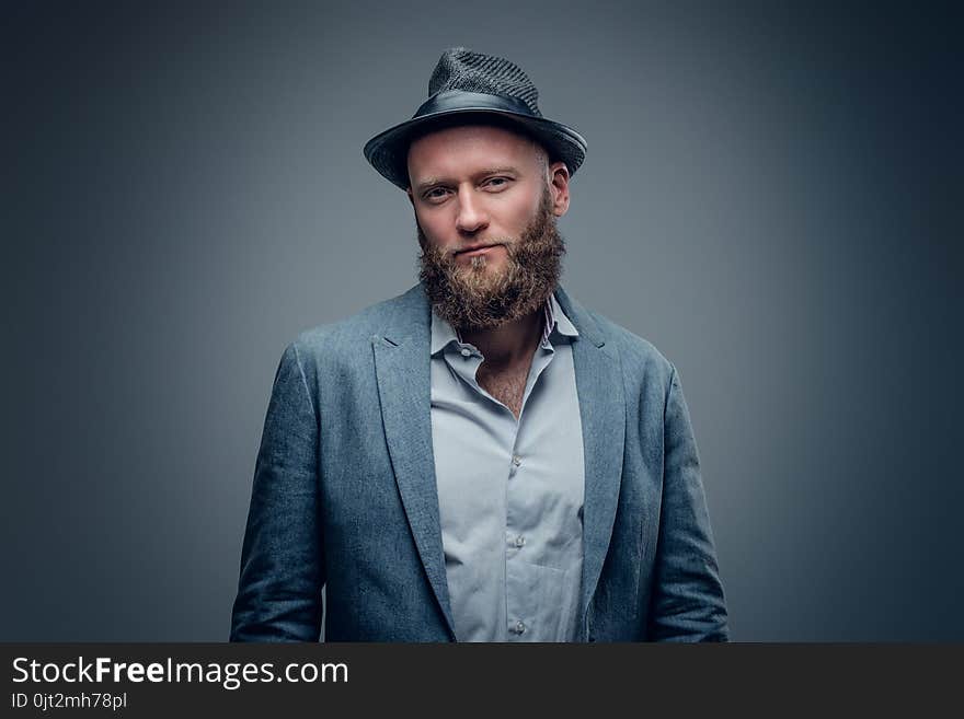 Bearded male in a suit and felt hat.