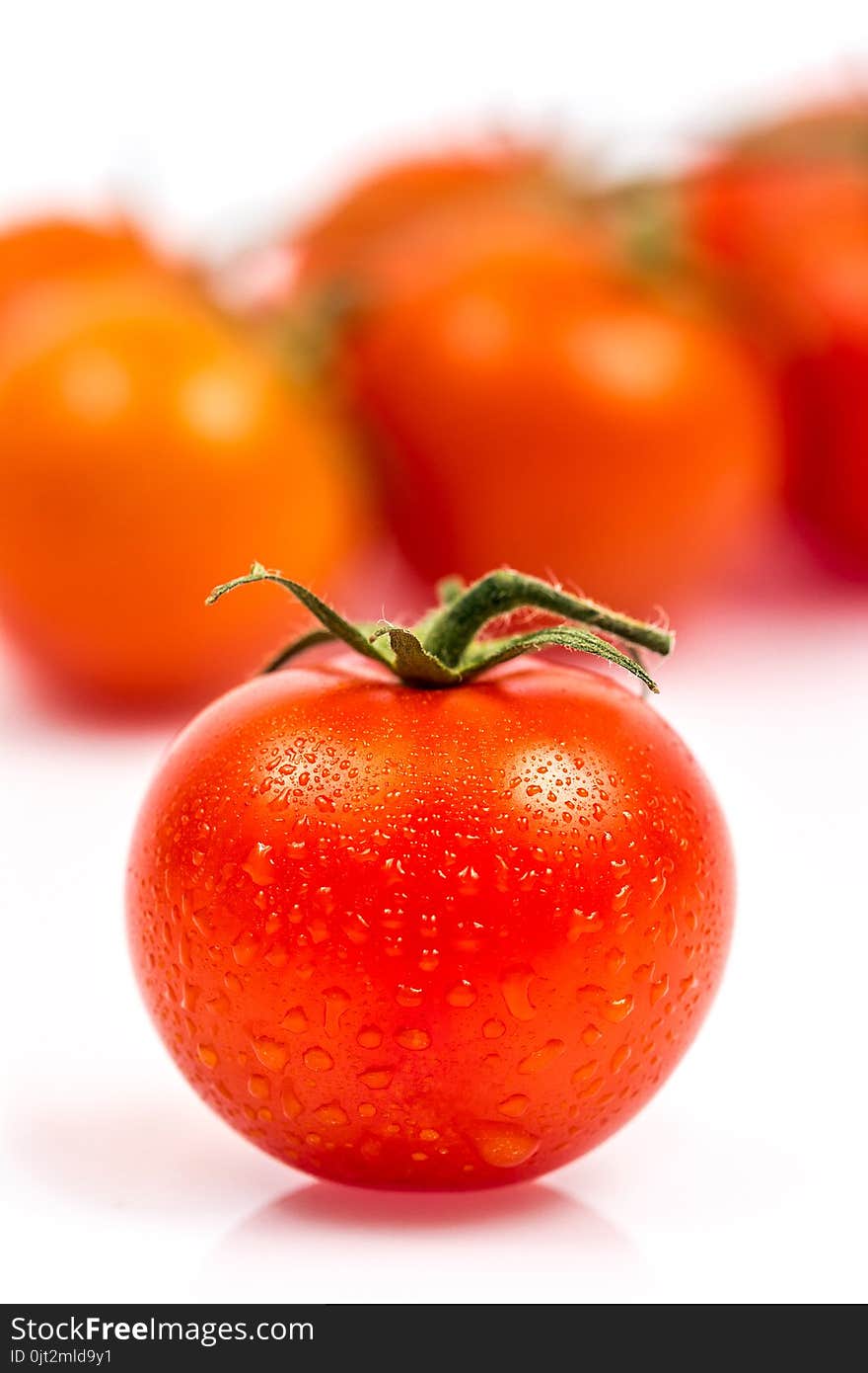 Tomato with water drops isolated on white background. Tomato with water drops isolated on white background