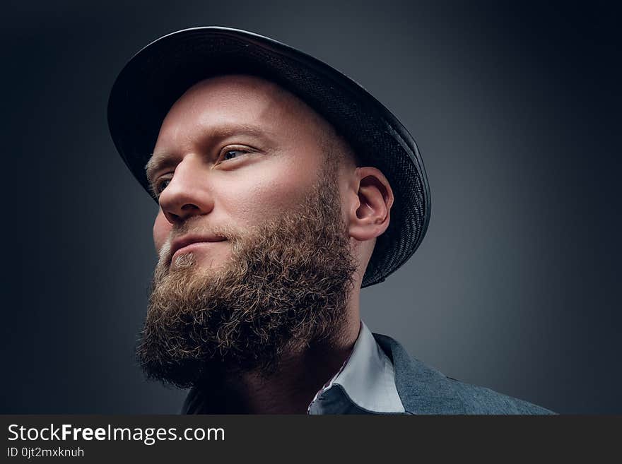 Close up portrait of bearded male in a felt hat.