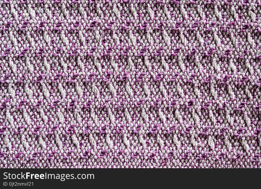 Texture of the fabric surface made of knitted natural cotton fiber, purple-lilac pattern, abstract background. Texture of the fabric surface made of knitted natural cotton fiber, purple-lilac pattern, abstract background