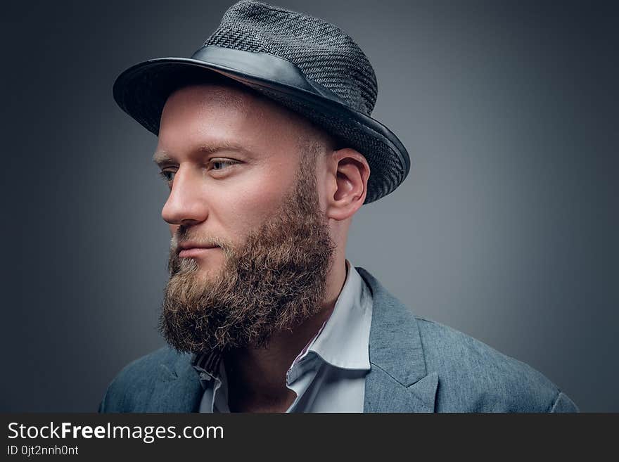 Close up portrait of bearded male in a felt hat.