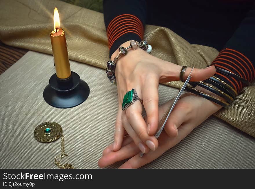 Tarot cards on fortune teller desk table. Future reading. Woman fortune teller holding in hands a deck of tarot cards and shuffles it. Tarot cards on fortune teller desk table. Future reading. Woman fortune teller holding in hands a deck of tarot cards and shuffles it.