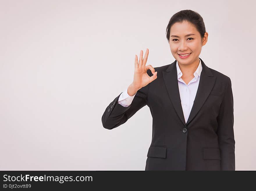 businesswoman pointing up ok hand sign.