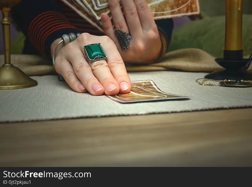 Tarot cards on fortune teller desk table. Future reading. Woman fortune teller holding and hands a deck of tarot cards. Tarot cards on fortune teller desk table. Future reading. Woman fortune teller holding and hands a deck of tarot cards.