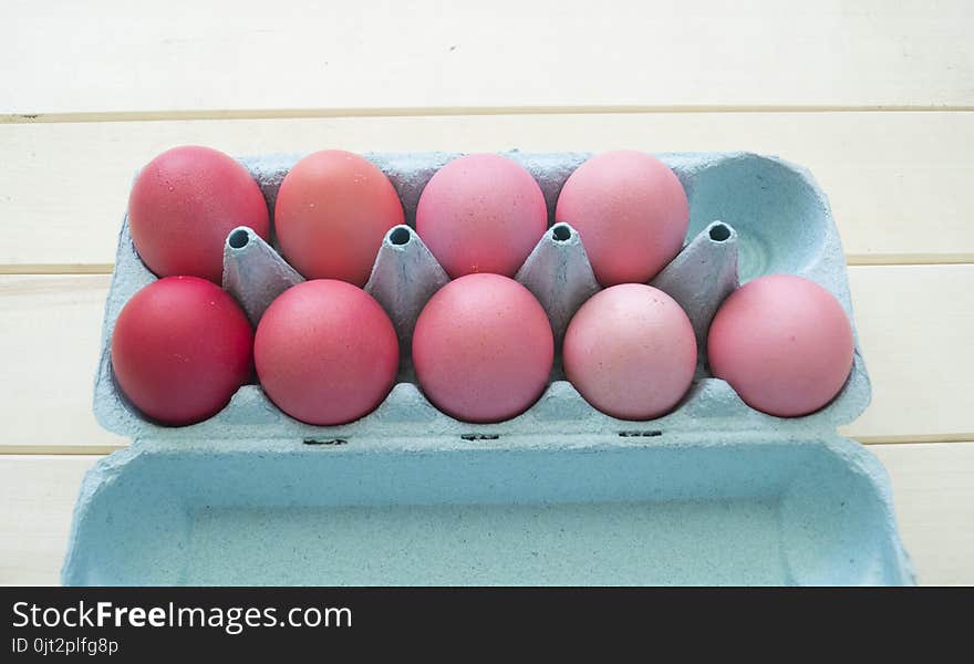 Easter.Pastel colored eggs.Spring composition.Flat ley.Many Easter eggs lie in a container for eggs. Curly eggs.Handmade.Wooden background. Basket woven