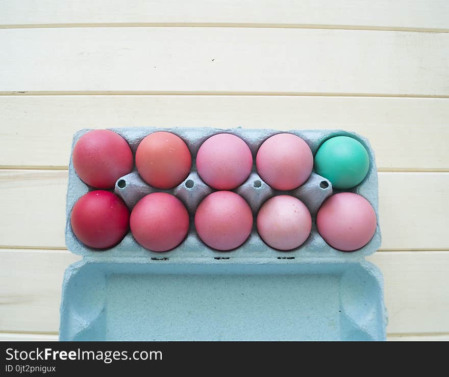 Easter.Pastel colored eggs.Spring composition.Flat ley.Many Easter eggs lie in a container for eggs. Curly eggs.Handmade.Wooden background. Basket woven