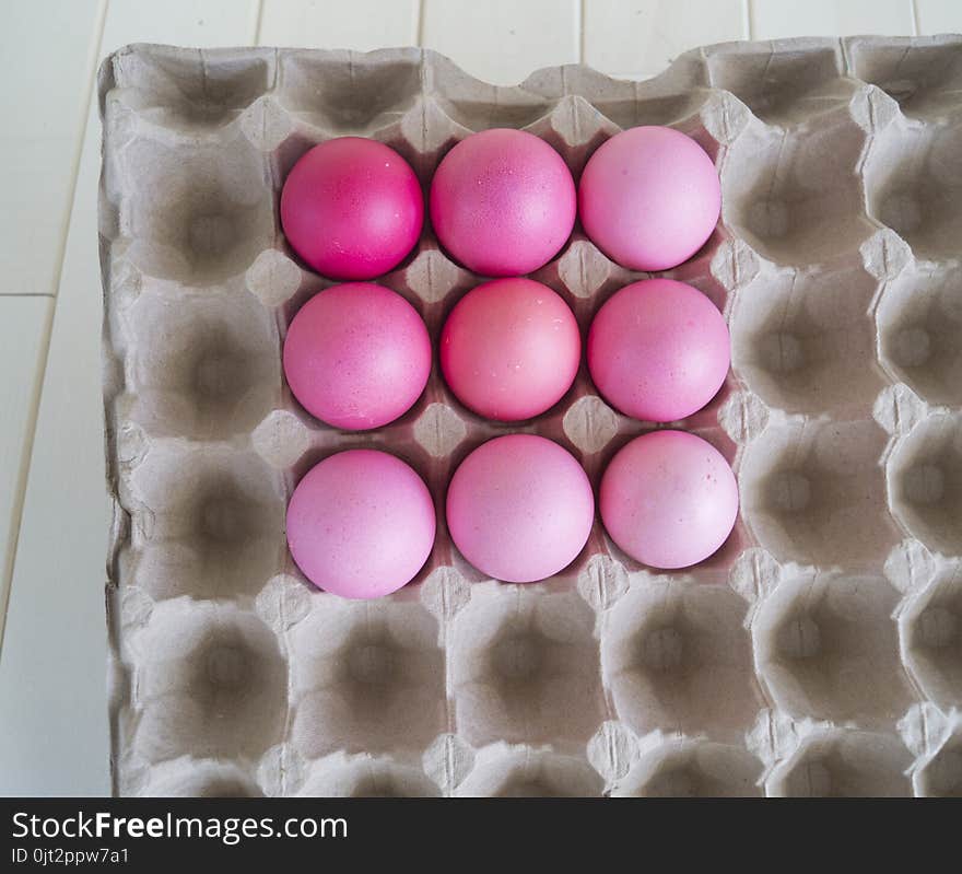 Easter.Pastel colored eggs.Spring composition.Flat ley.Many Easter eggs lie in a container for eggs. Curly eggs.Handmade.Wooden background. Basket woven