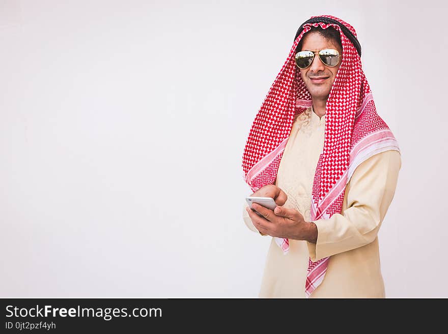 Arab businessman useing on a mobile phone.