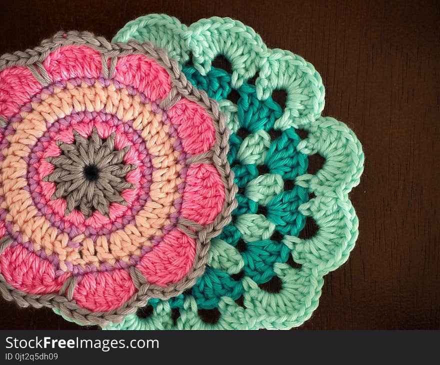 Knitting saucer, crochet work on the table, Top view of pink yarn