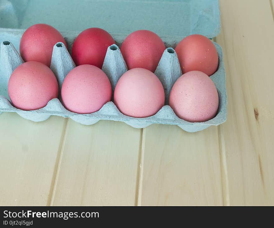 Easter.Pastel colored eggs.Spring composition.Flat ley.Many Easter eggs lie in a container for eggs. Curly eggs.Handmade.Wooden background. Basket woven