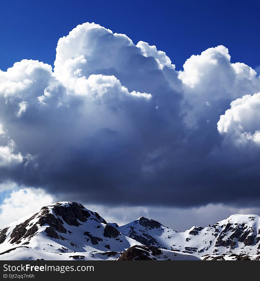 Snowy Mountains And Sky With Clouds