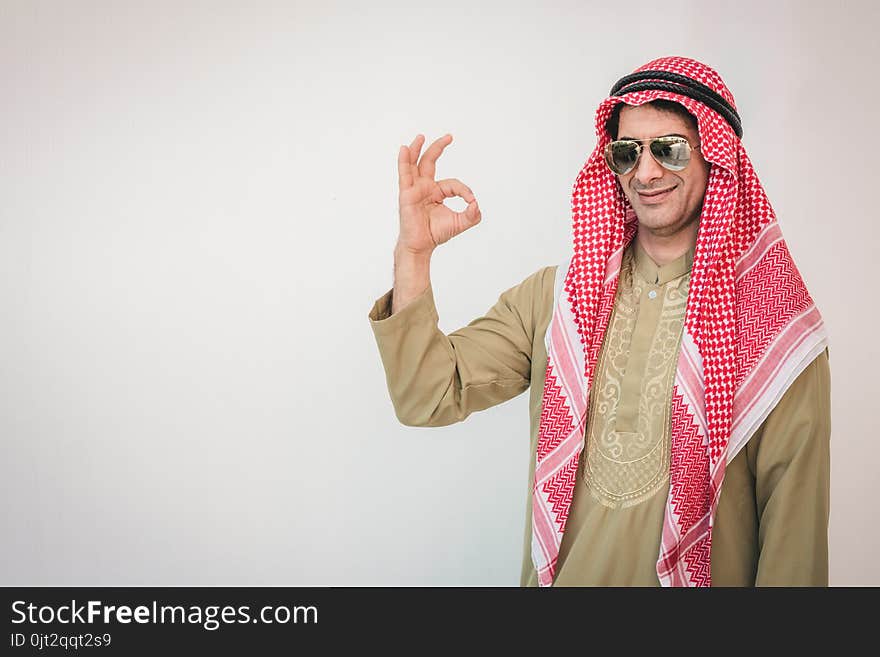 Arab businessman pointing up ok hand sign, man