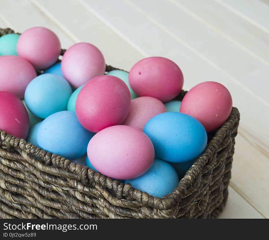 Easter.Pastel colored eggs.Spring composition.Flat ley.Many Easter eggs lie in a container for eggs. Curly eggs.Handmade.Wooden background. Basket woven