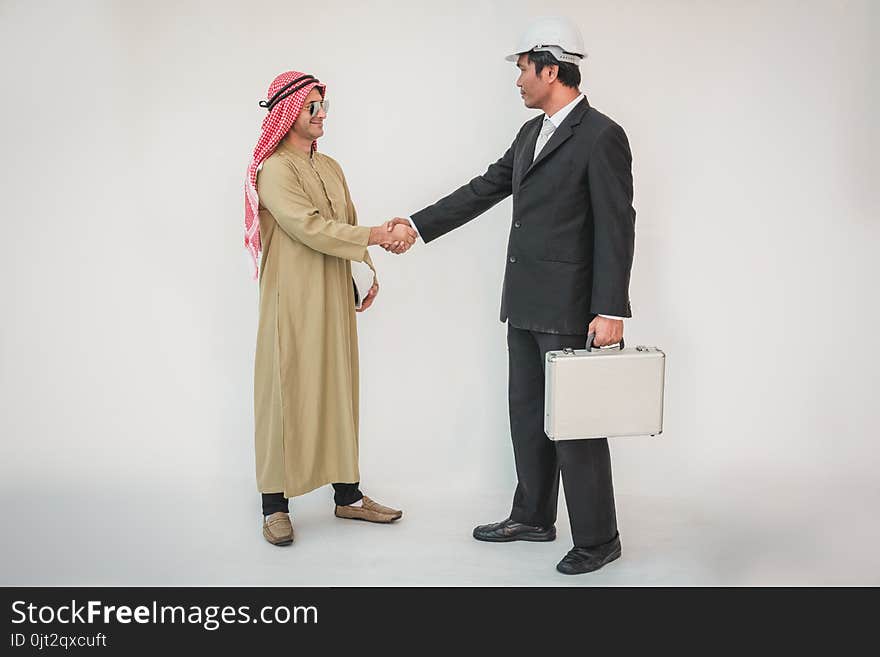 Arab businessman and foreman worker handshaking, man