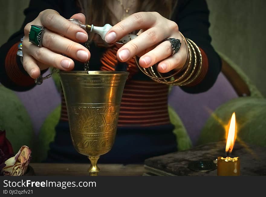 Woman witch prepare a magic potion. Future reading. Tarot cards on fortune teller desk table. Woman witch prepare a magic potion. Future reading. Tarot cards on fortune teller desk table.