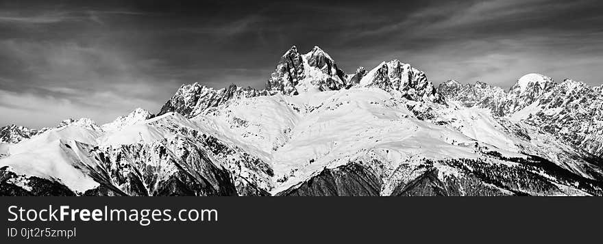 Black and white panoramic view on Mount Ushba at wind sunny day. Caucasus Mountains. Svaneti region of Georgia.