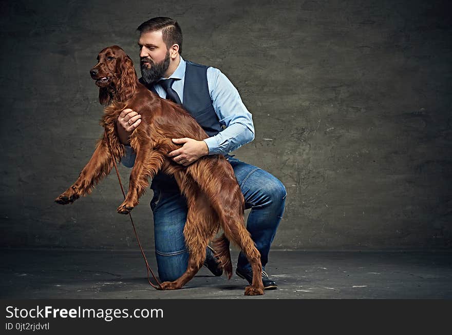 Stylish bearded middle age male and his mammals friend Irish red setter. Stylish bearded middle age male and his mammals friend Irish red setter.