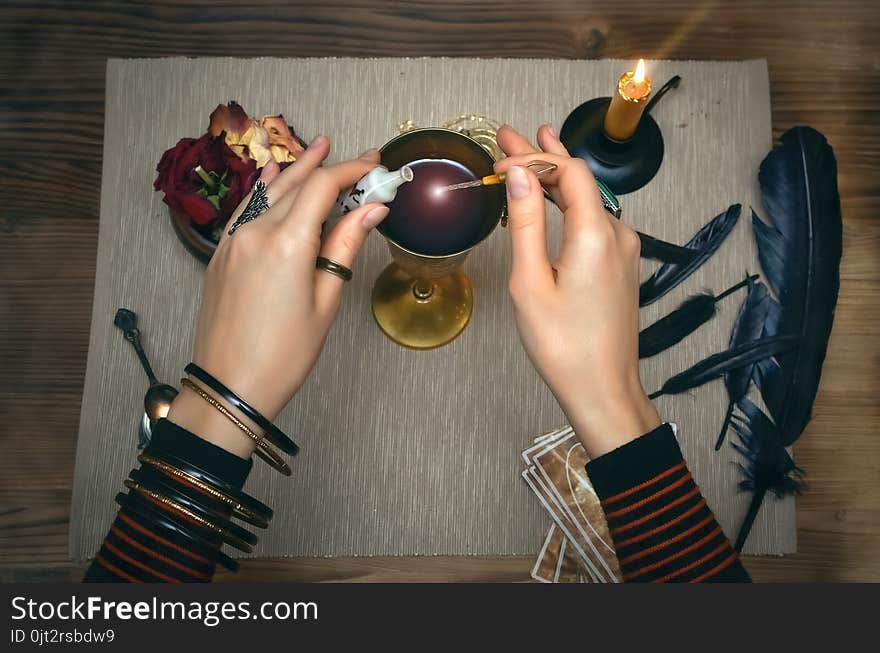 Woman witch prepare a magic potion. Future reading. Tarot cards on fortune teller desk table. Woman witch prepare a magic potion. Future reading. Tarot cards on fortune teller desk table.