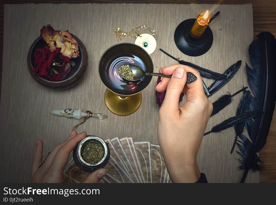 Woman witch prepare a magic potion. Future reading. Tarot cards on fortune teller desk table. Woman witch prepare a magic potion. Future reading. Tarot cards on fortune teller desk table.